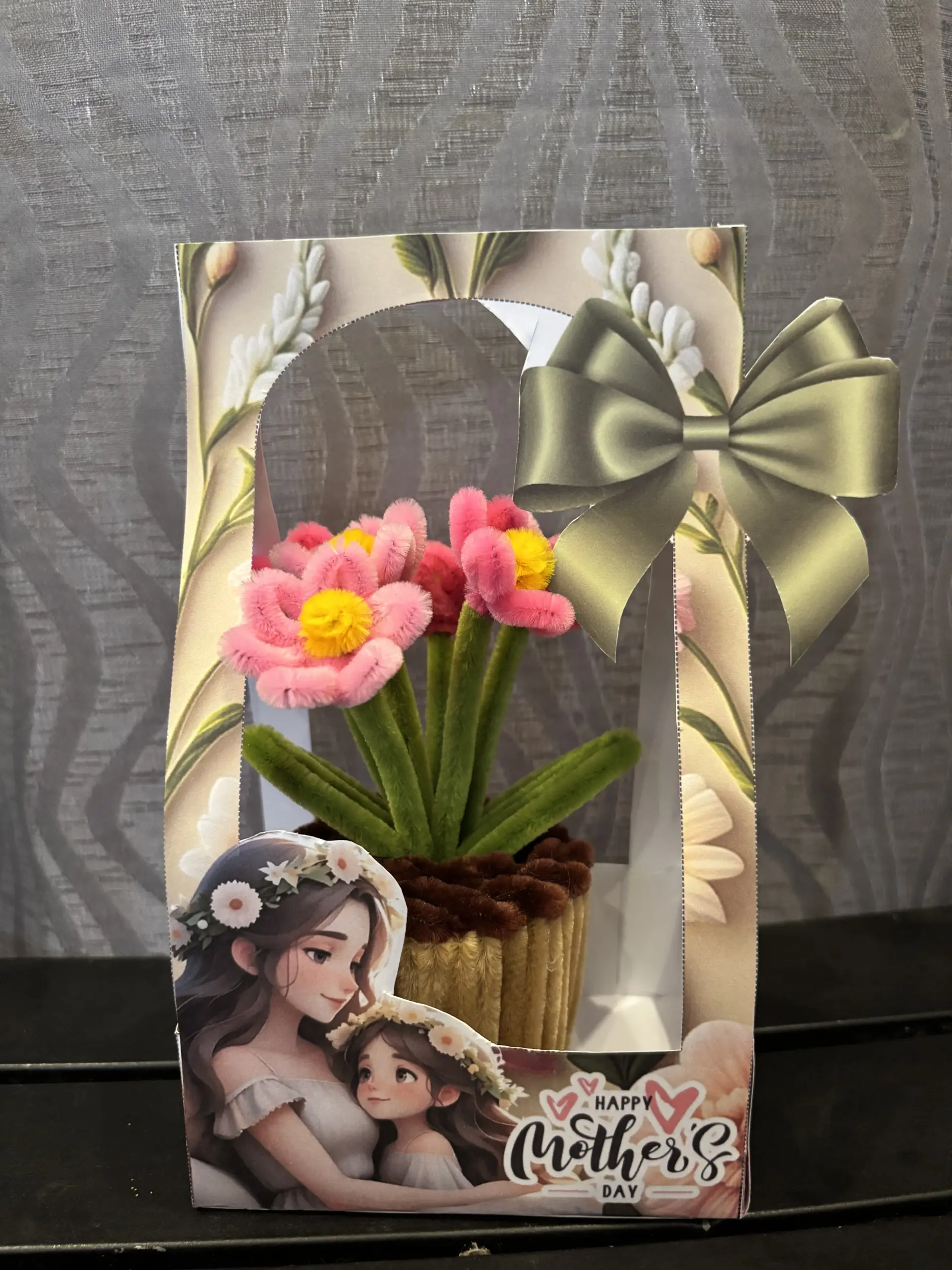 FleurKraft mini pot salmon — coral-toned fuzzy wire flower in a woven basket pot with gift packaging